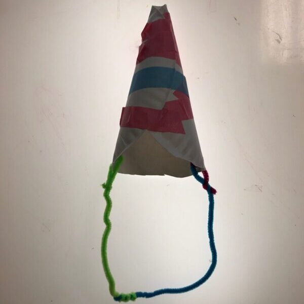 A birthday hat made from a rolled up paper plate.