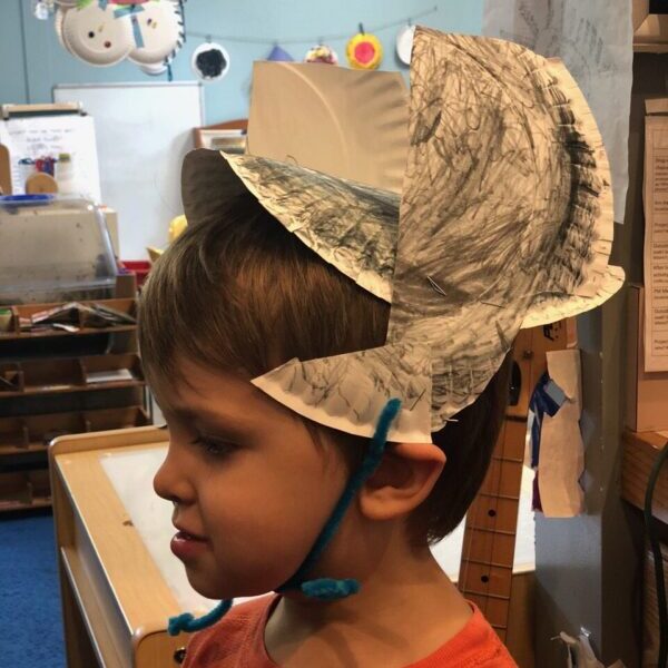 A winged Norse helmet made from a paper plate helm with cutout plate wings on either side.