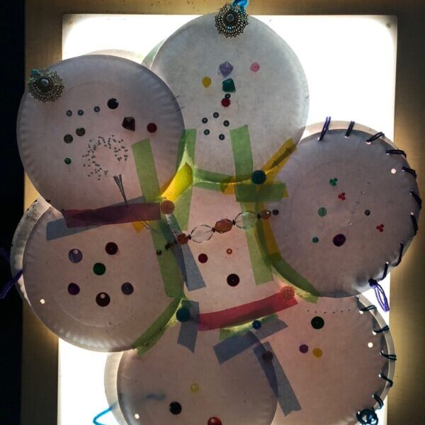 Several paper plates taped together and decorated to look like a sparkling cloud.