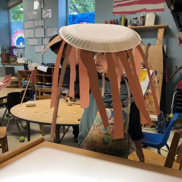 Jellyfish constructed from a paper plate with tentacles.
