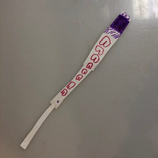A wand made from a slice of a paper plate.